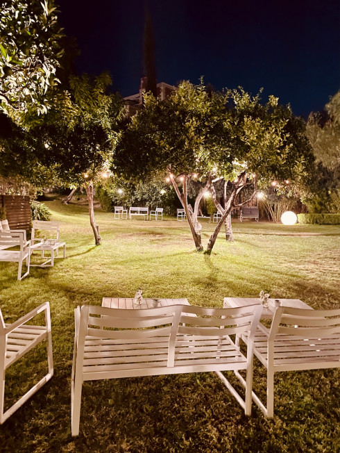 The venue grounds in the evening, lit up with soft lights hanging off the trees.