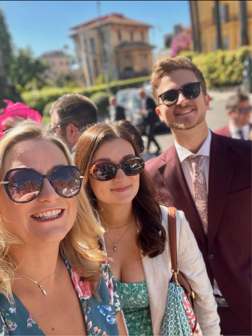 Sarah, Emma, and Oliver outside the wedding venue, wearing sunglasses in the glorious sunshine.