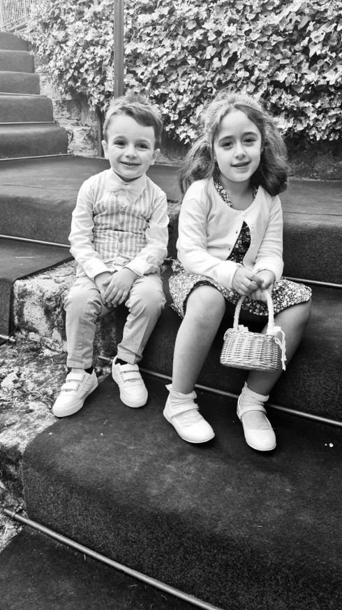 Sergio and Chiara sat on carpetted steps in the garden.