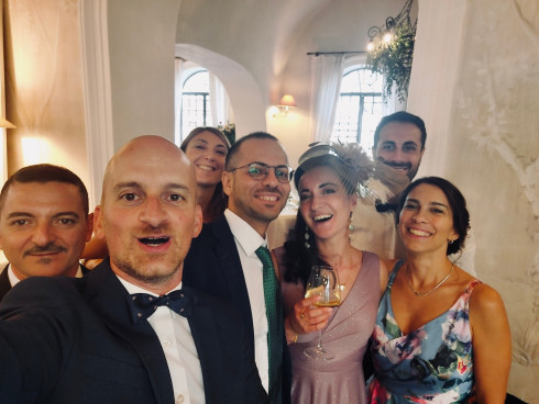 Filly's friends gathered together with Clara in the middle with a glass of white wine.