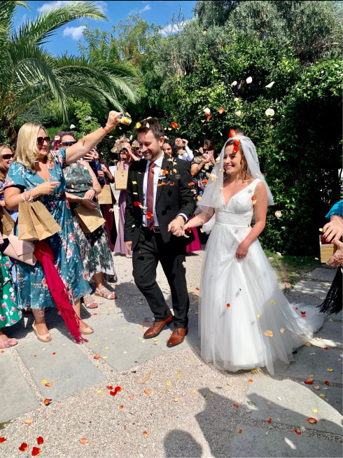 Everyone throwing confetti over Jay and Filly after they've been married.