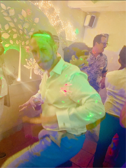 Dave with drink in hand pulling a dance move.