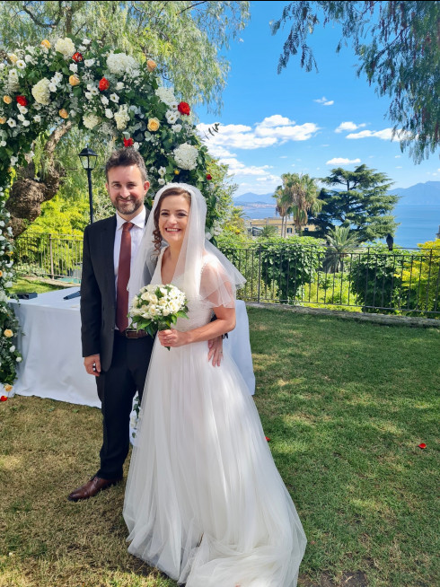 Jay and Filly in front of the wedding arch.