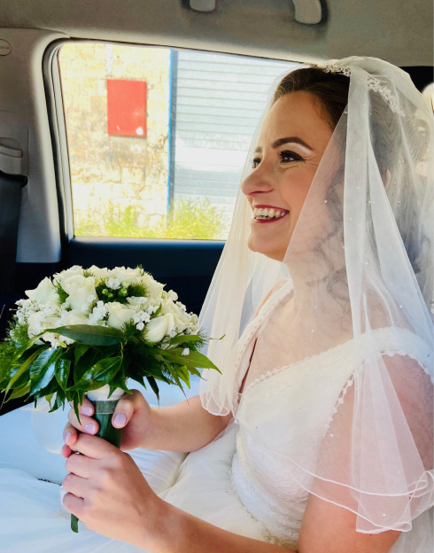 Filly in the taxi with a bouquet of flowers.