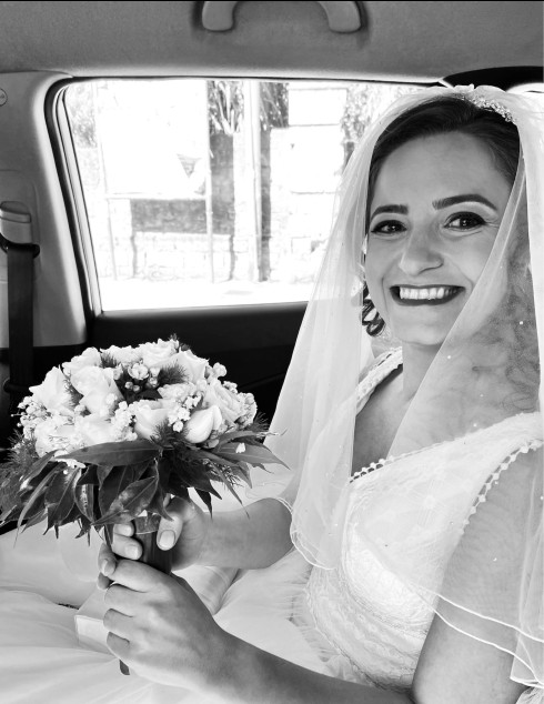 Filly with her bouquet in the car on the way to the wedding.