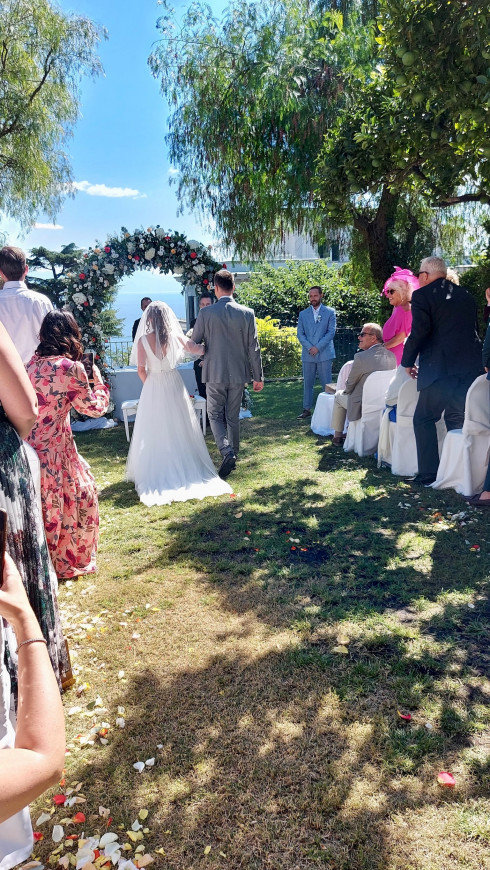 Filly and Giulio arrive at the end of the aisle.