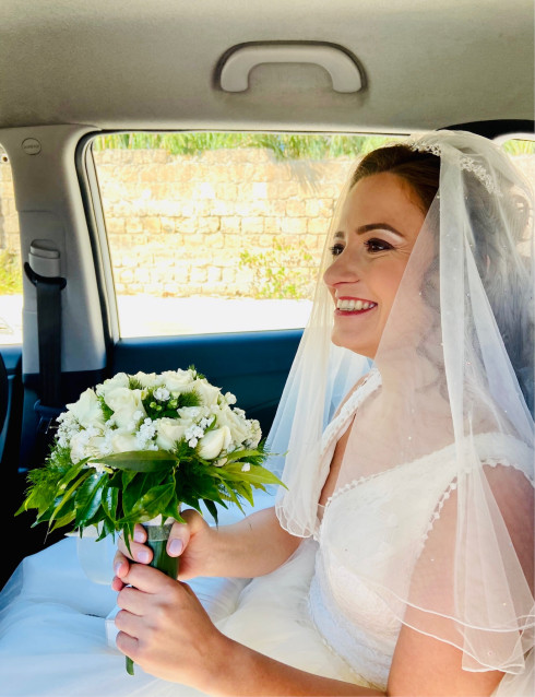 Filly in the taxi with a bouquet.