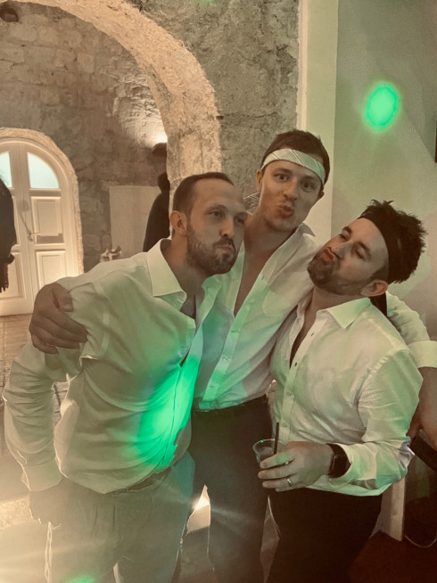 Dave, Pete and Jay pull mock kissing gestures on the dancefloor.