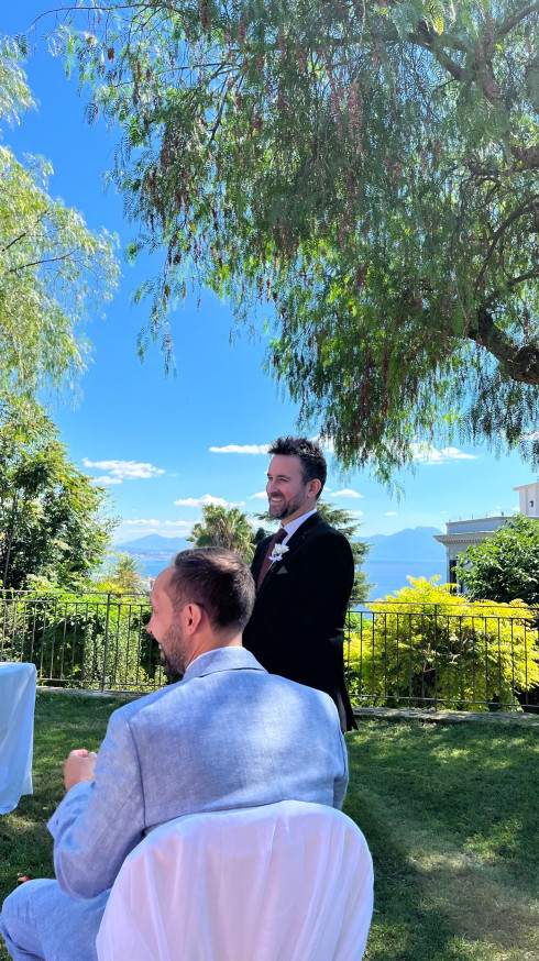 Jay and Dave laughing at the front of the flower alter.