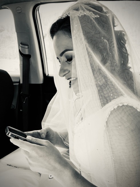 Filly looking at her mobile phone in the taxi.