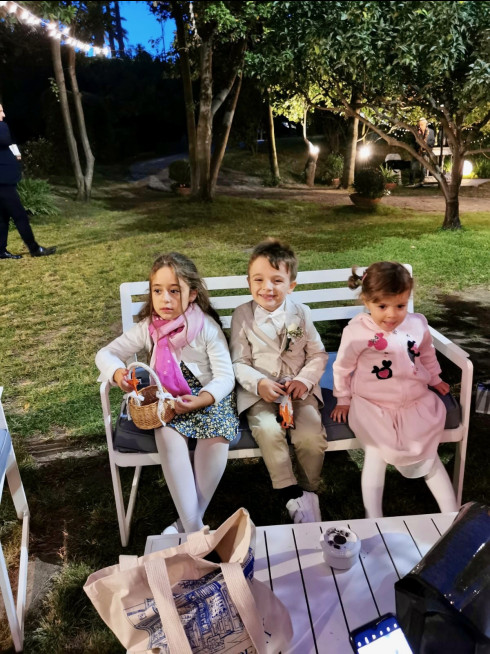 Chiara, Sergio, and Emma sat on a bench.