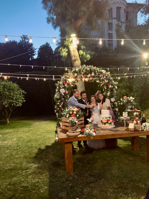 Dave, Jay, Filly, and Clara cut the cake together.