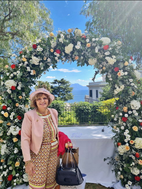 Concetta, Filly's aunt, stood in front of the wedding arch.