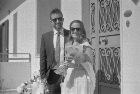 Jay and Filly on the steps of Filly's family house in Marigliano, with Filly holding some flowers.