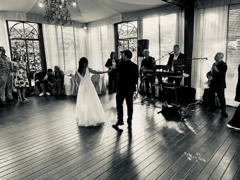 Filly and Jay slow dancing in front of the band.