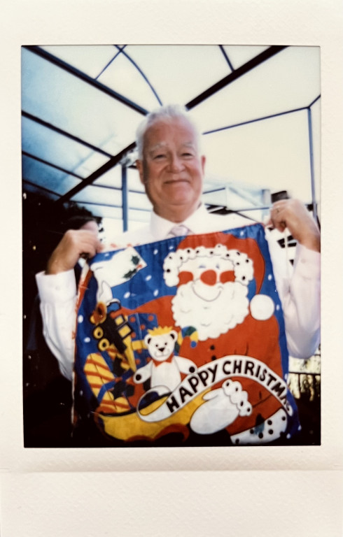 Uncle David holding up the santa sack smiling knowingly.