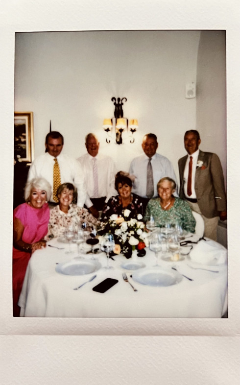 Wives and Husbands gathered around a table.
